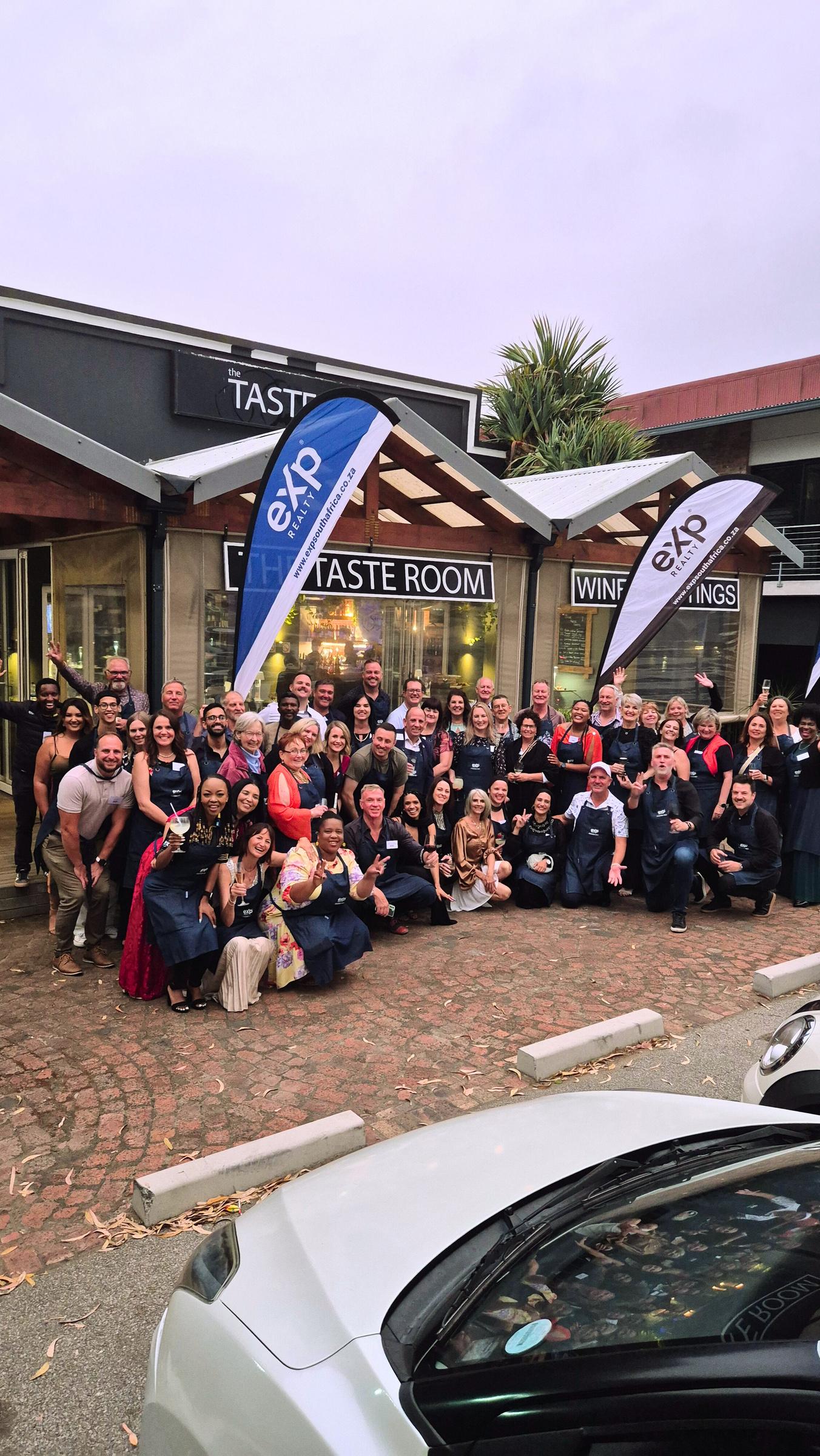 Outdoor eXp team gathering, with agents together outside a venue